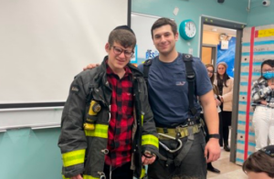 student dressed as a fire fighter for career day.